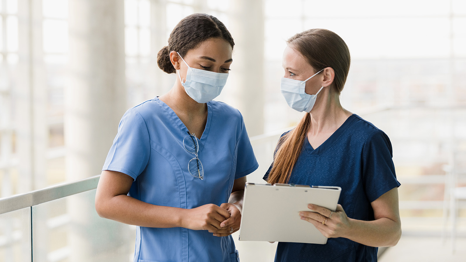 Nurses looking at clipboard