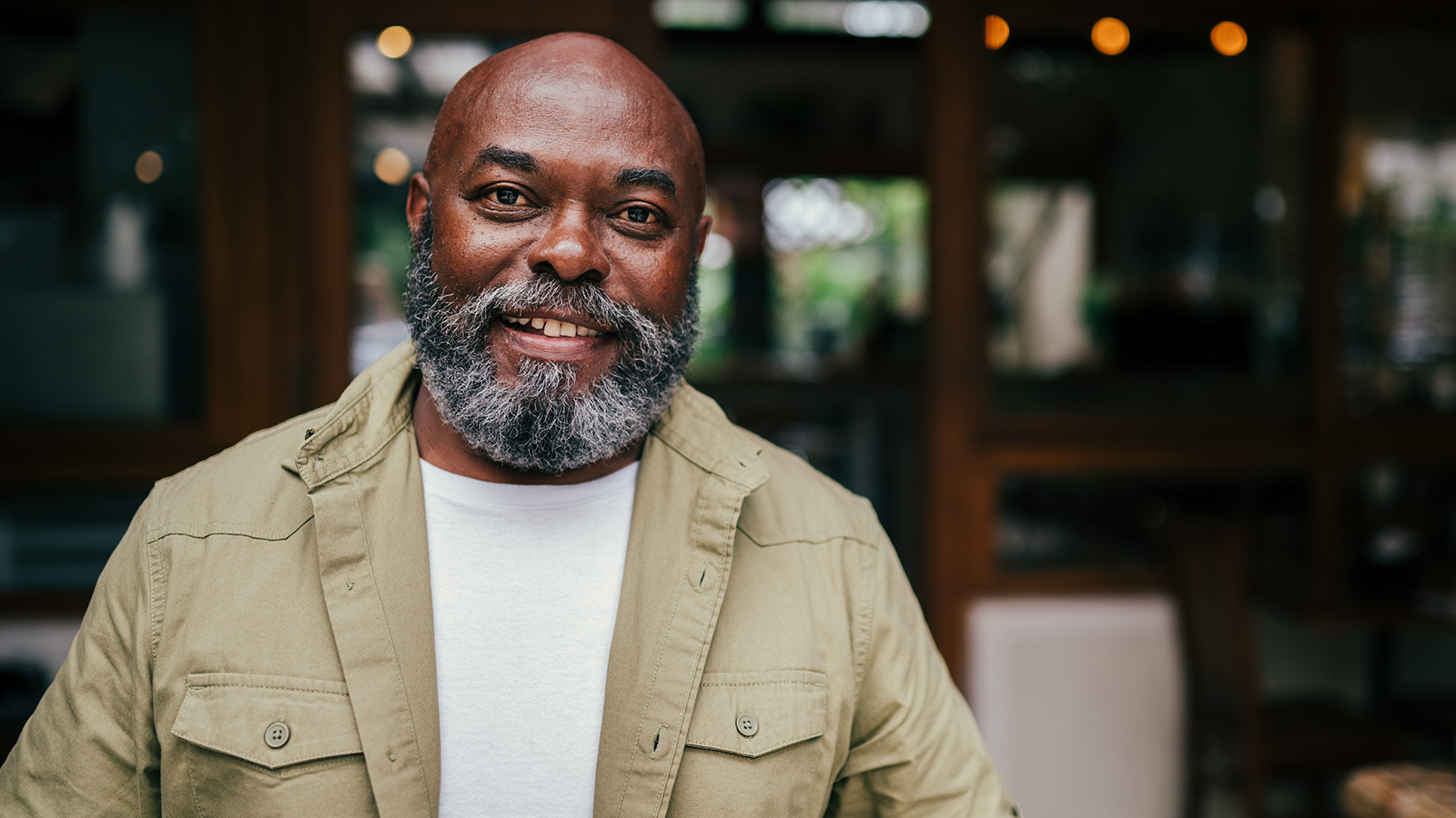 Middle-aged man in restaurant smiling
