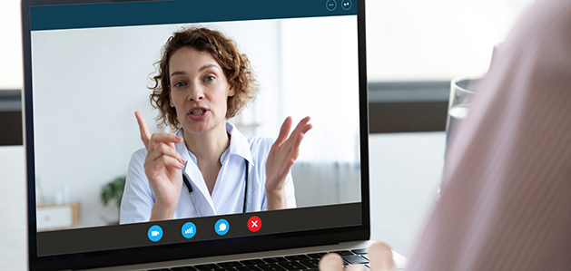 A patient meets virtually with a female doctor