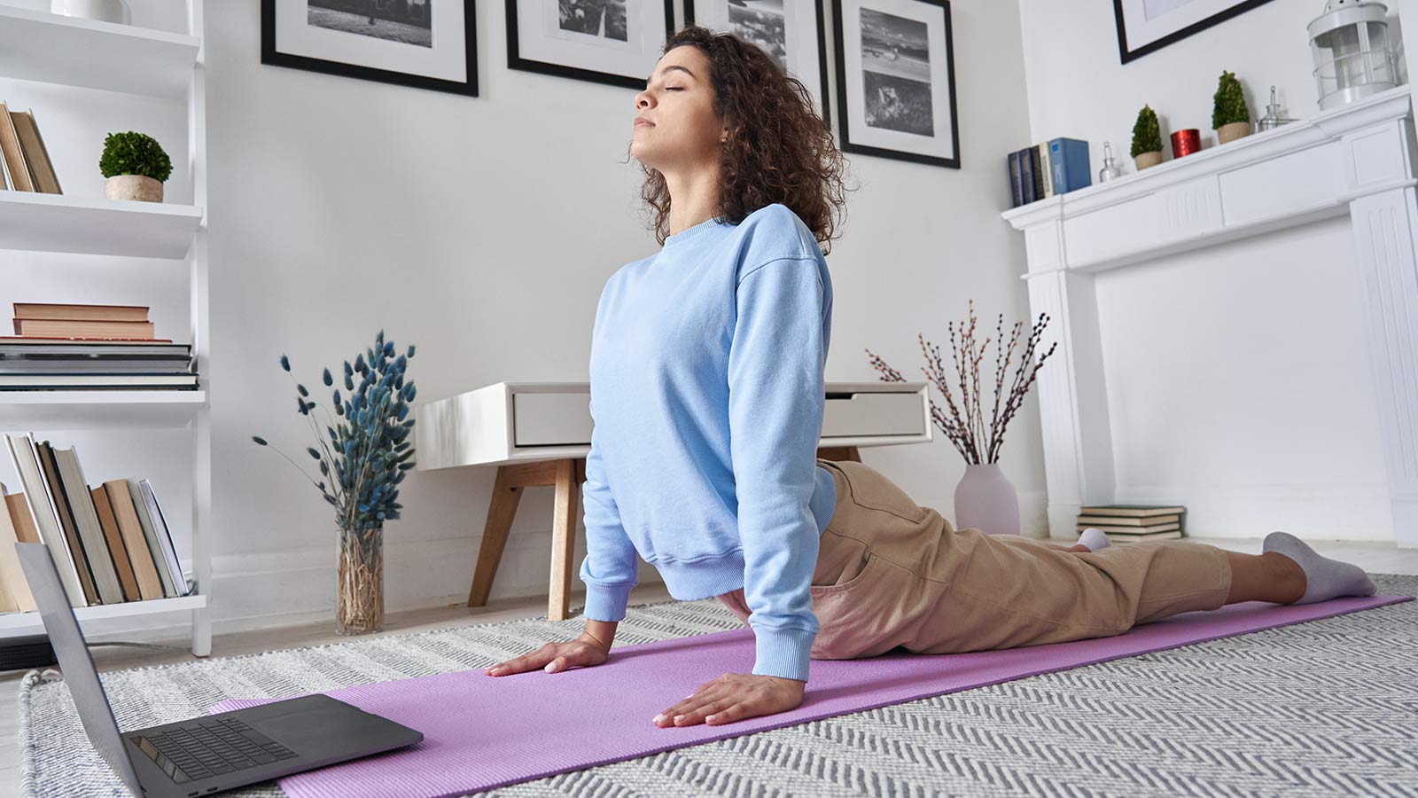 young woman doing yoga at home