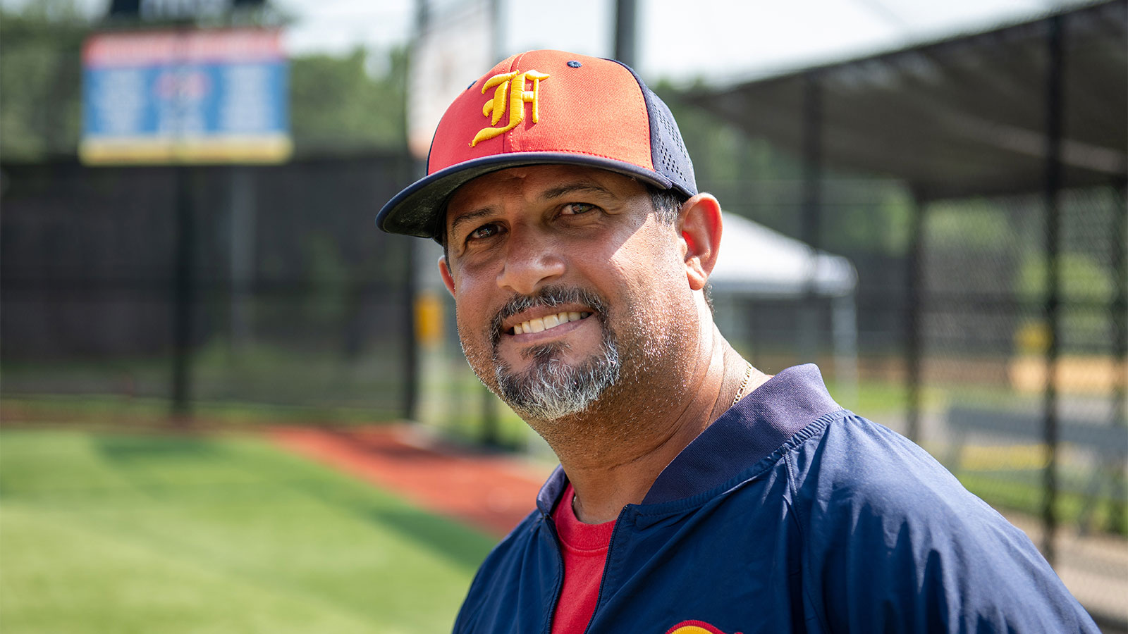 Virtua male breast cancer patient shown in baseball field wearing a baseball uniform