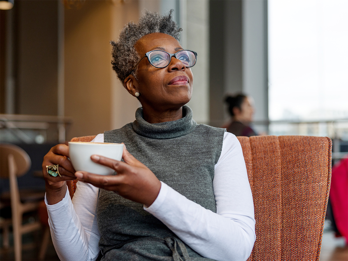 Middle Aged African American Woman Sipping Coffee at a Restaurant
