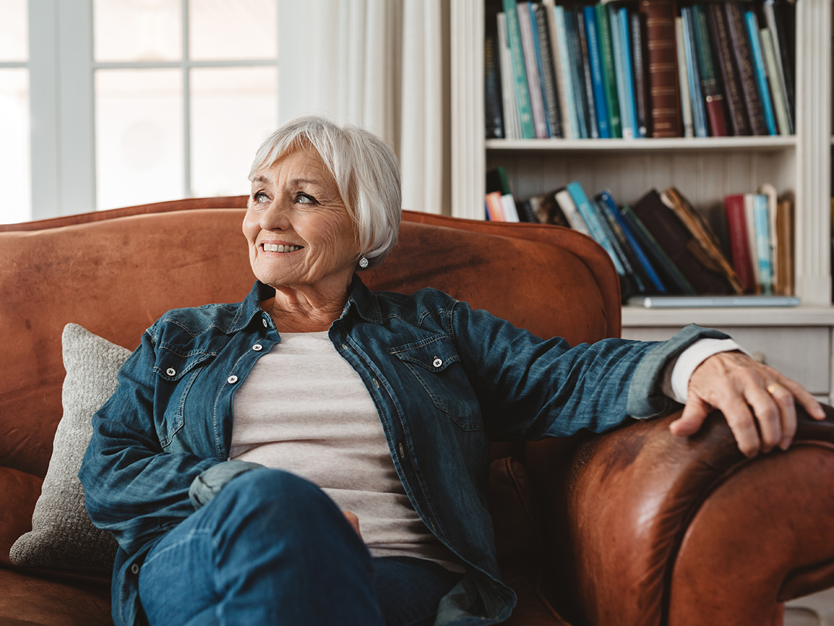 Older Caucasian woman relaxing in a leather chair